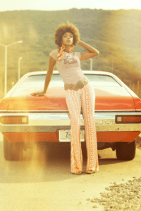 t-shirt-mockup-of-a-woman-posing-with-a-car-in-the-70s-