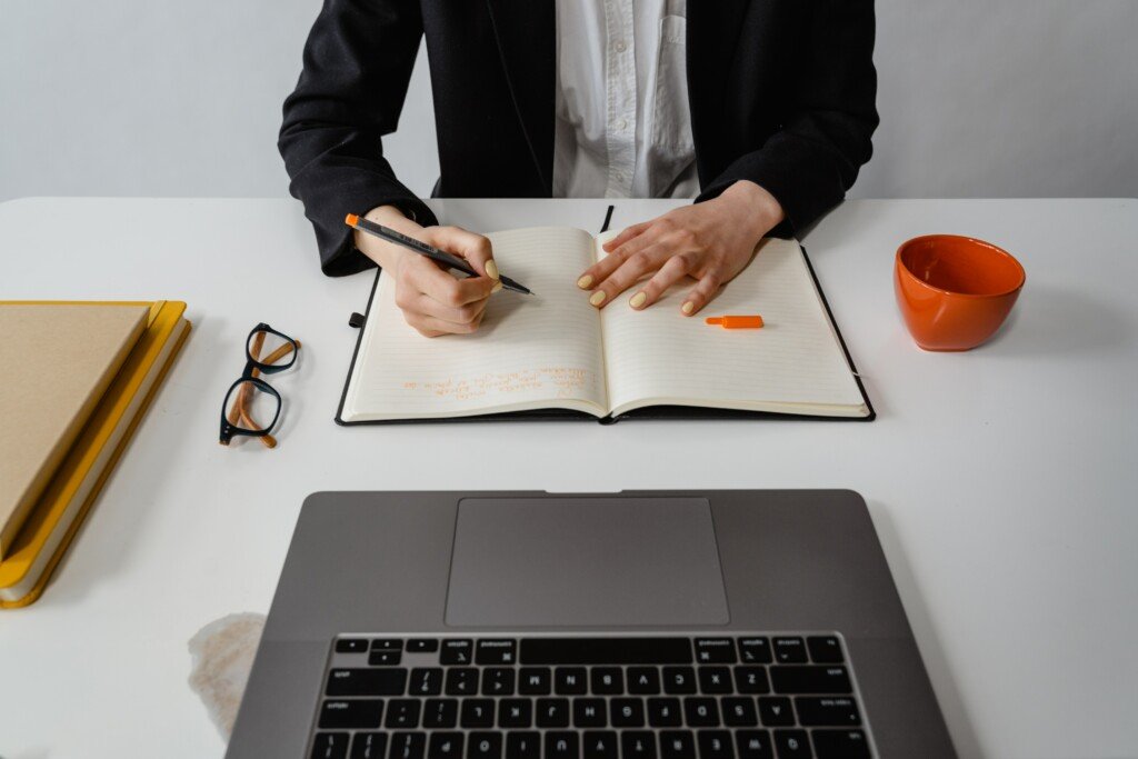 man in a office with notebook and computer