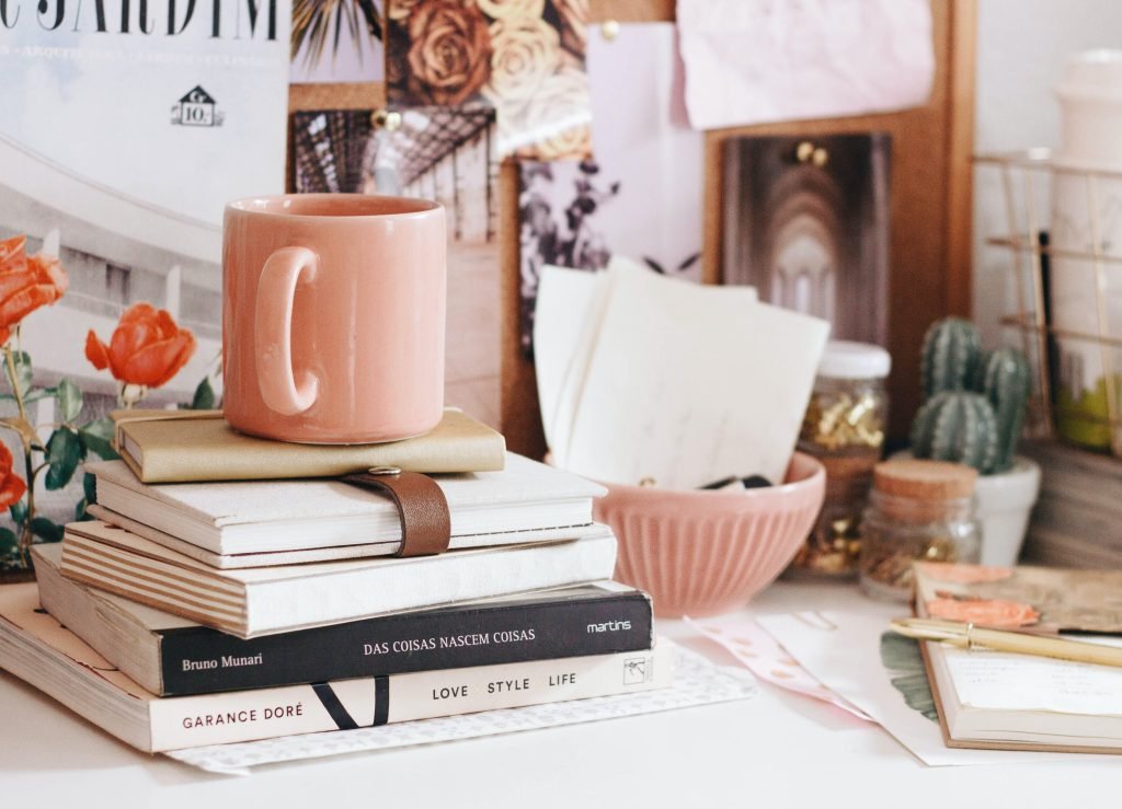 books and mug s on a desk