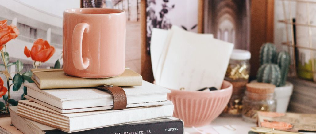 books and mug s on a desk