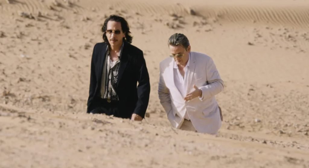 2 men walking in the desert