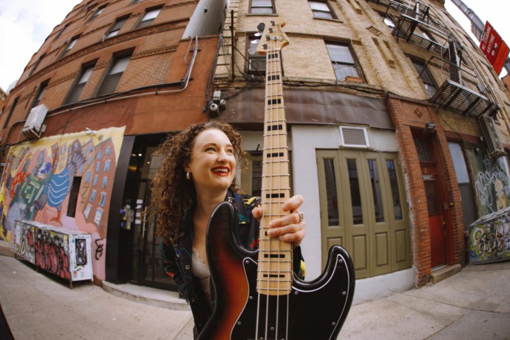 woman holding a bass guitar