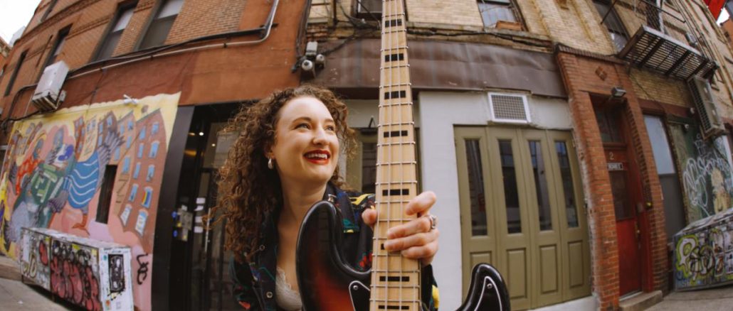 woman holding a bass guitar