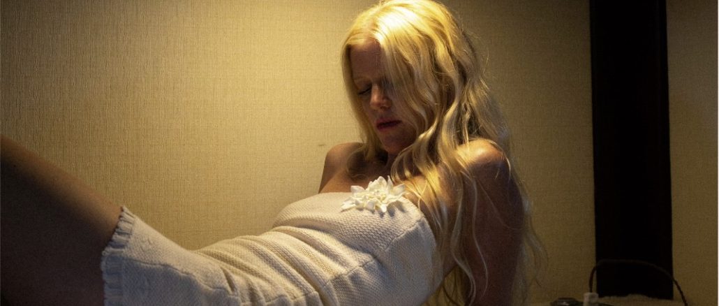 blond woman with a short white dress laying in bed