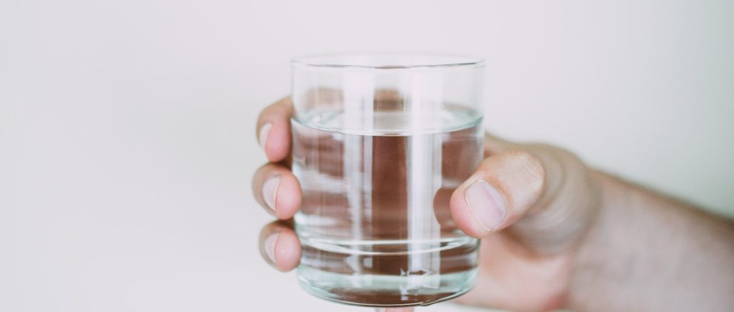 hand holding a glass of water