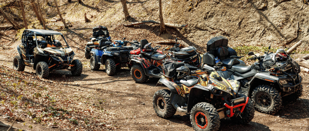 Group of Quad ATV cars all terrain vehicle parked on mountain road