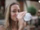 photo-of-smiling-woman-drinking-water-from-a-plastic-bottle-3763929/