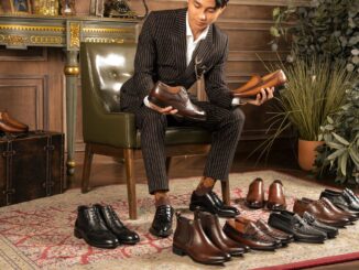 elegant mam sitting and looking at luxury derby shoes