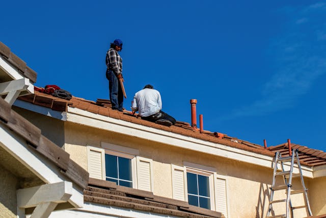 a couple of men on a roof