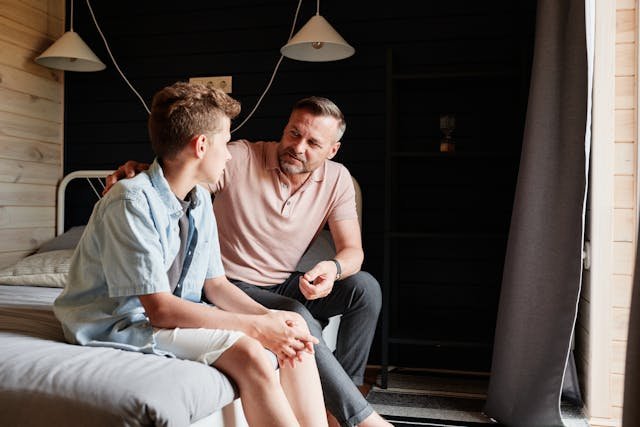 A parent talking with a child in a supportive, warm setting.