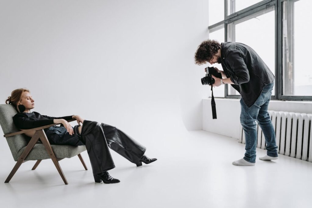 model reclining on a chair-at a photo session by a fashion photographer