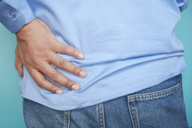 person in blue shirt an blue denim jeans with hand on hips