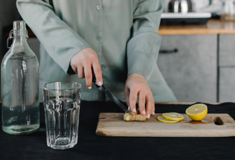 Preparing a healthy morning drink with lemon and ginger to boost weight loss