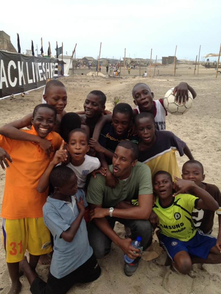 •	Dominick Robinson poses with a group of young boys while volunteering at an orphanage in Jamestown, Accra, Ghana.